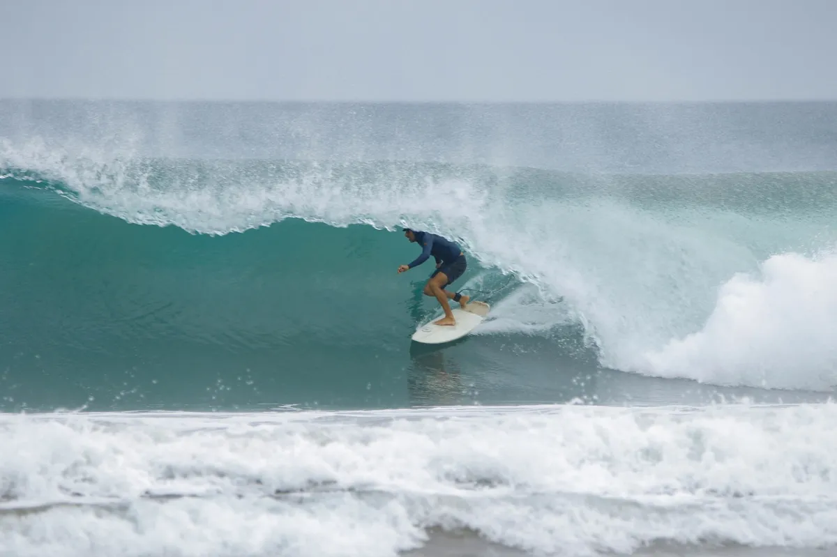 Surfer perfectly riding a barrel at Playa Colorado.