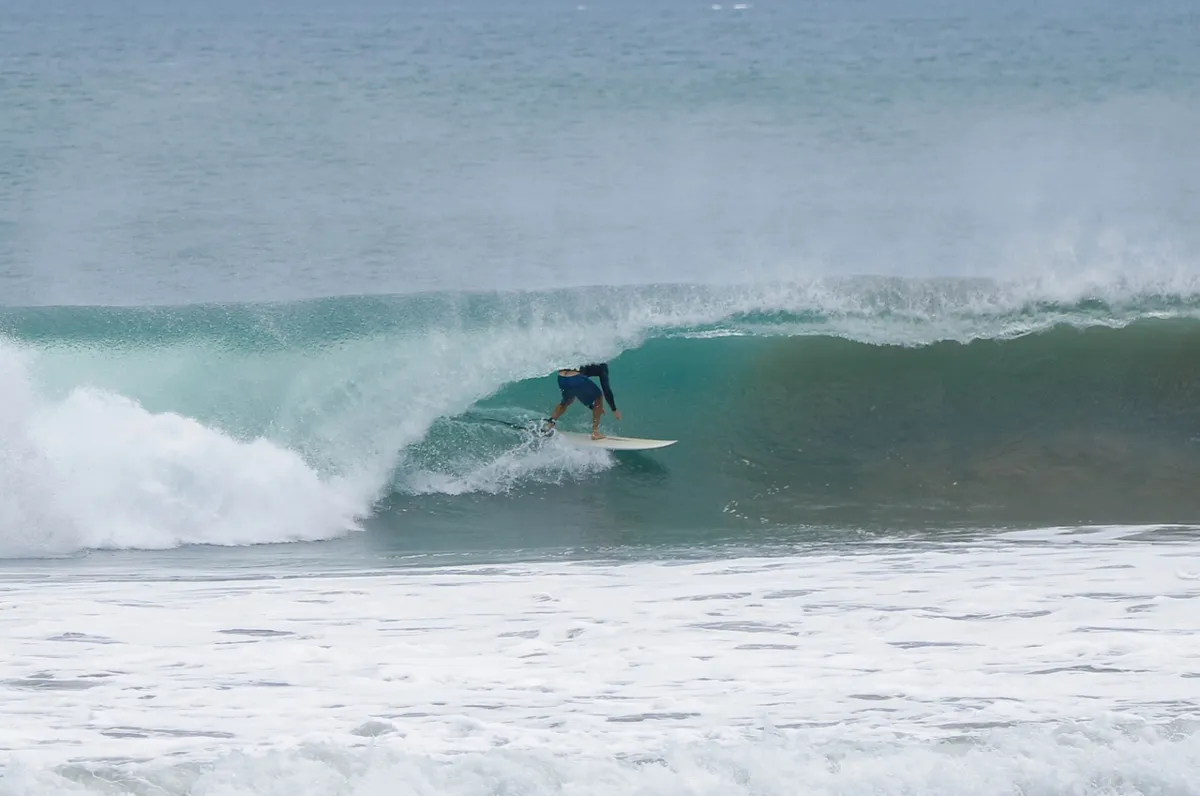 Surfer skillfully tucked inside a perfect barrel at Playa Colorado.