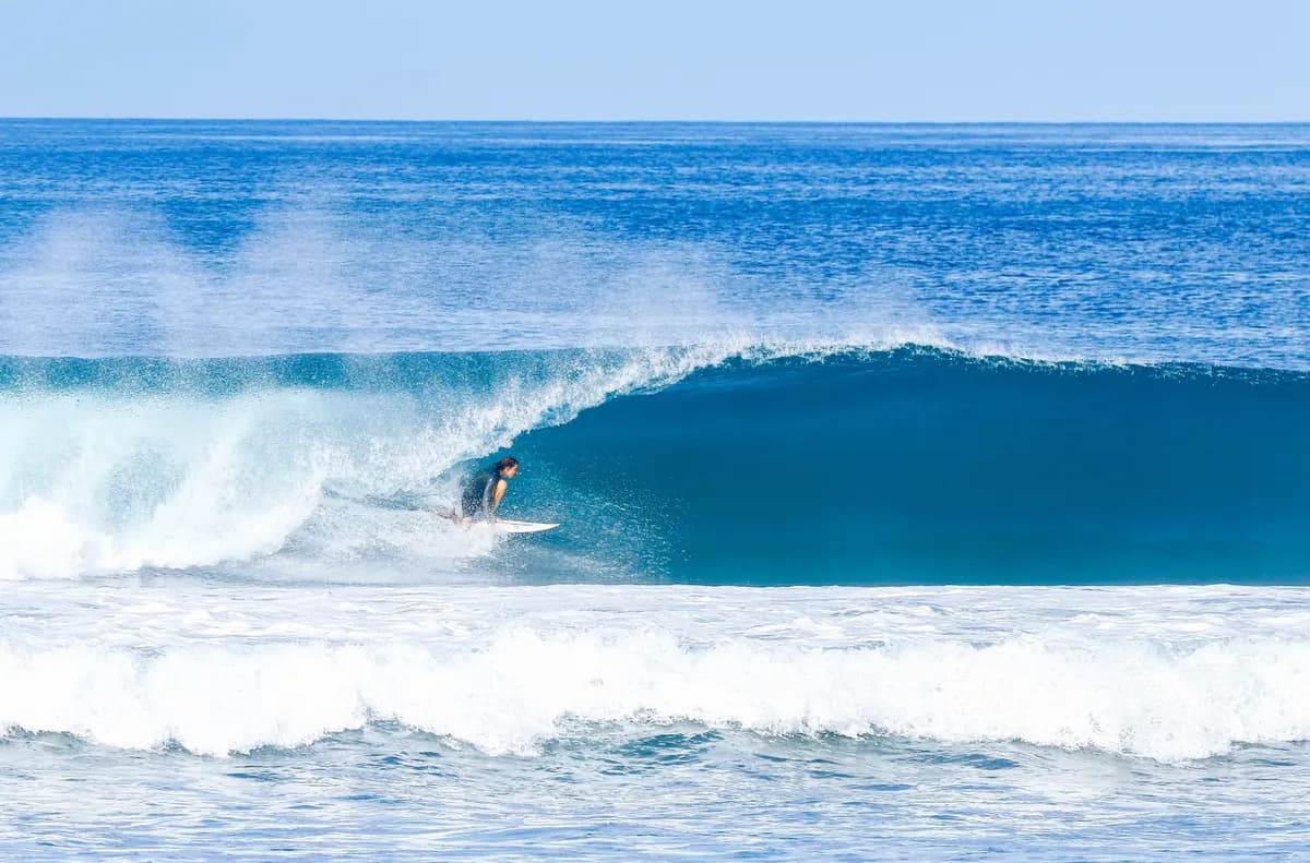 Surfer rides a perfect right barrel at Playa Colorados.