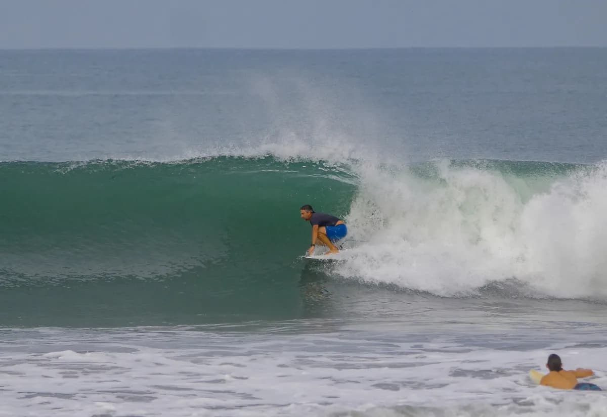 Surfer rides inside a green barrel wave.