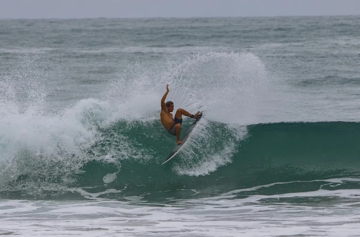 Surfer carves a powerful turn on a breaking wave.
