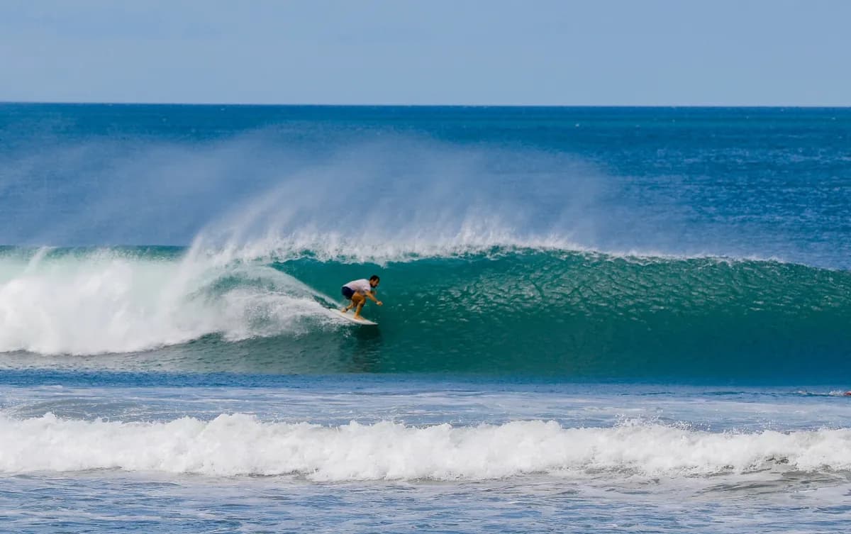 Surfer rides inside a perfect barrel wave.