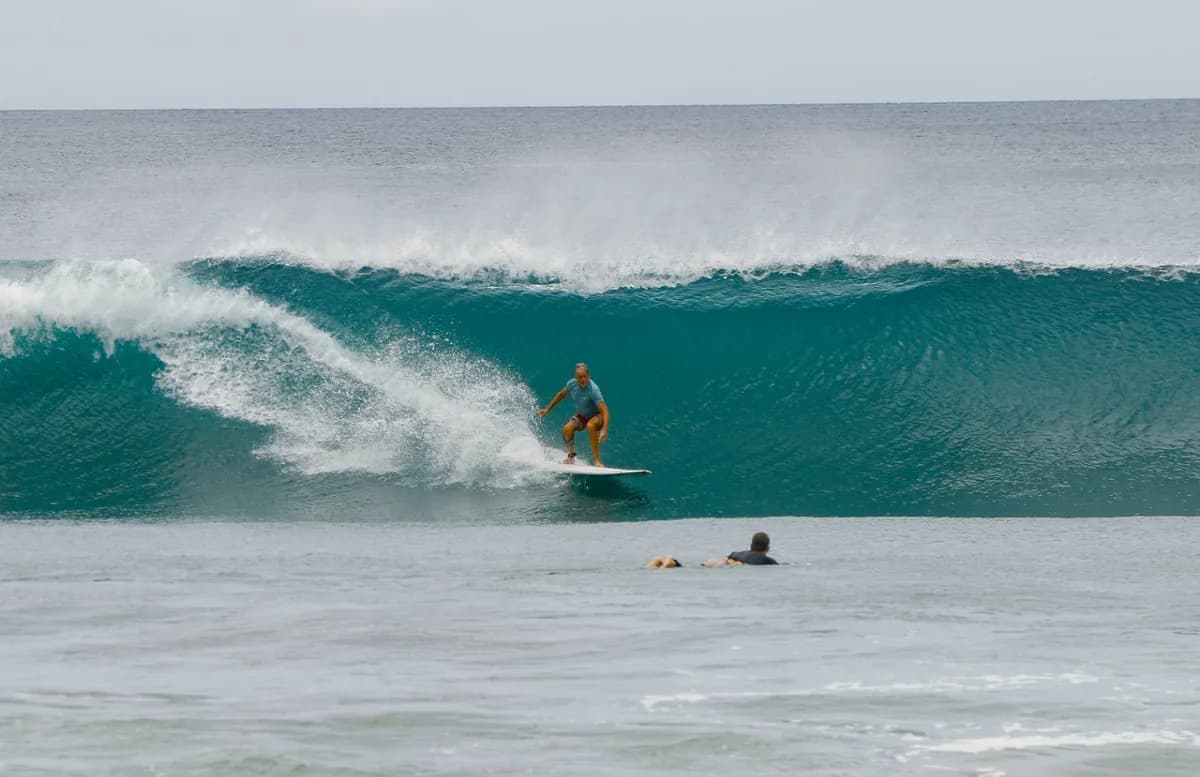 Surfer rides a clean right-hand wave at Playa Colorado.