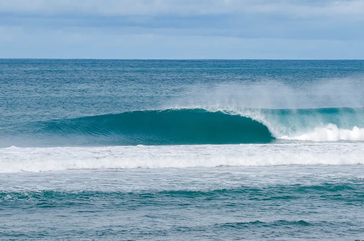Perfect hollow wave rolling with no surfers visible.