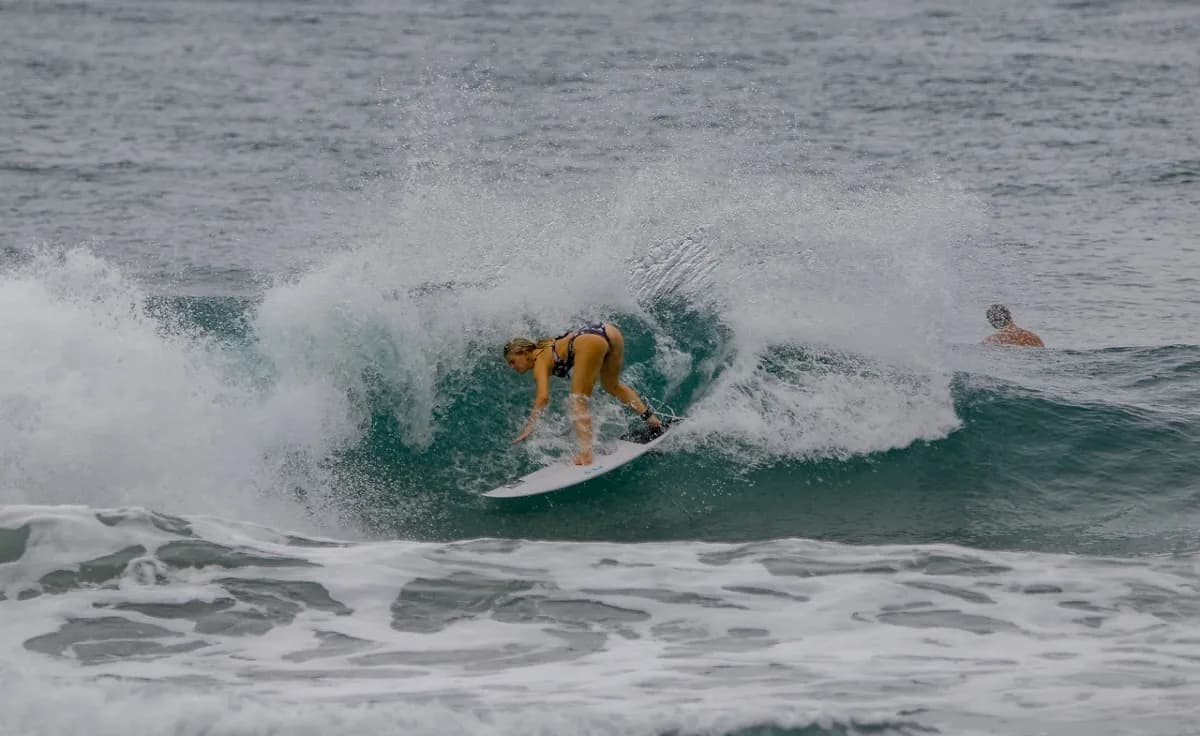 Surfer gracefully rides through a crashing wave.