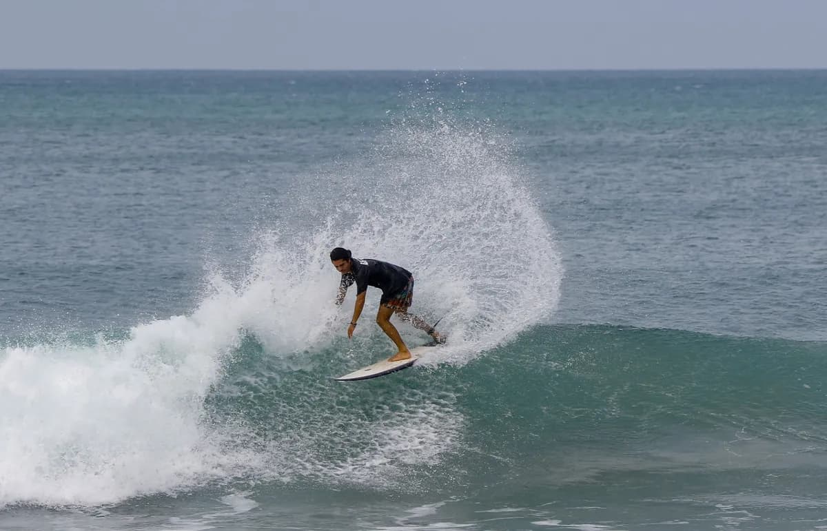 Surfer executing a dynamic cutback on a small wave.