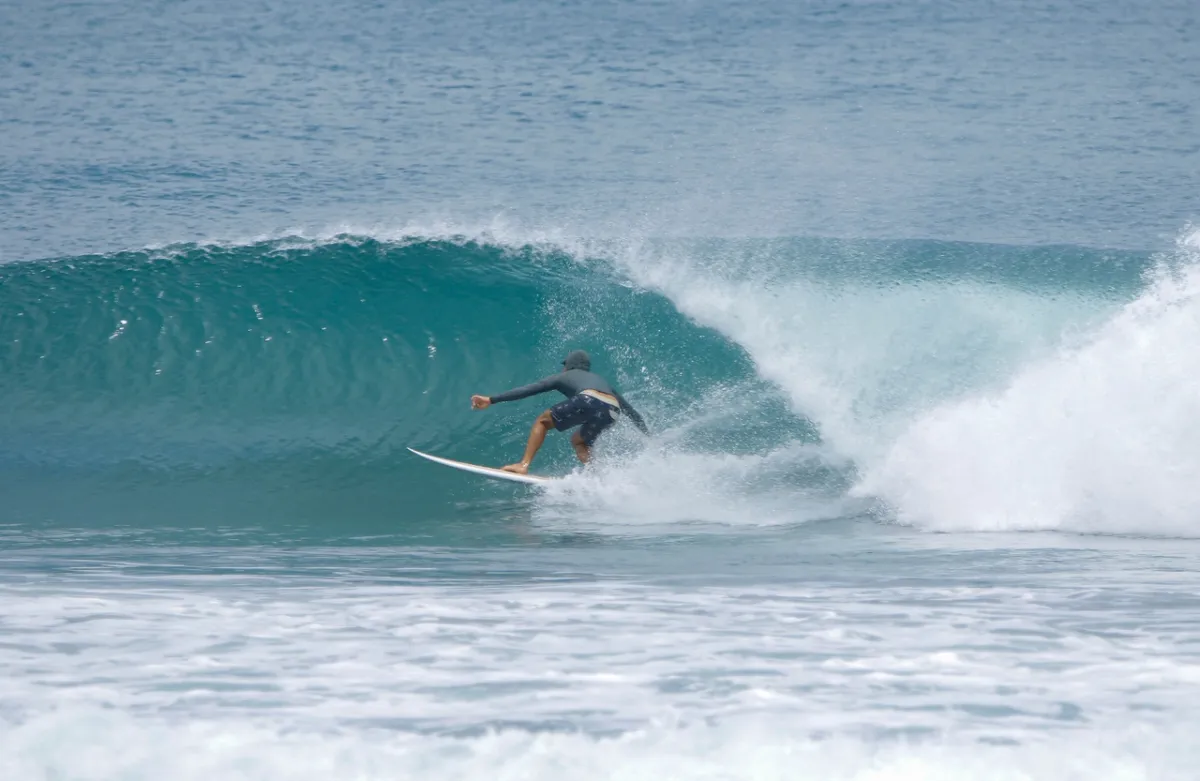 Surfer riding clean barrel with perfect wave form.