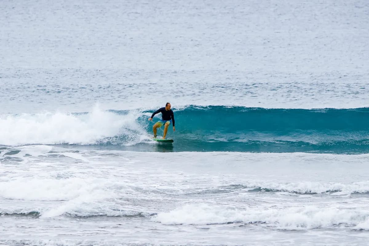 Surfer carves a small wave at Panga Drops.