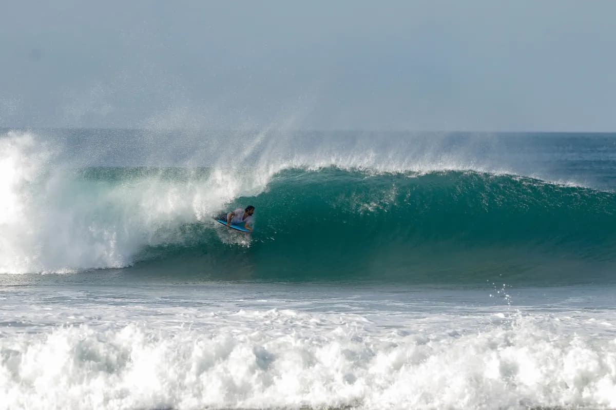 @marcos-muscuriello rides deep inside a perfect curling barrel.