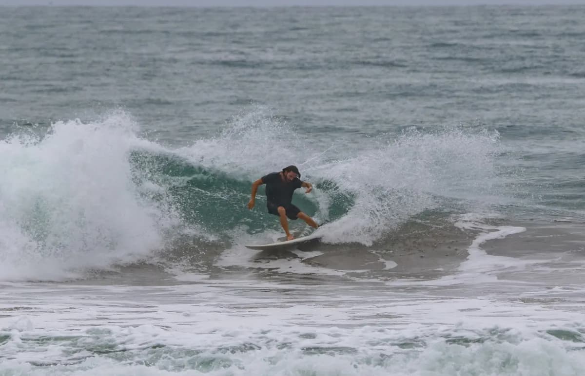 Surfer carves a tight turn on a powerful wave.