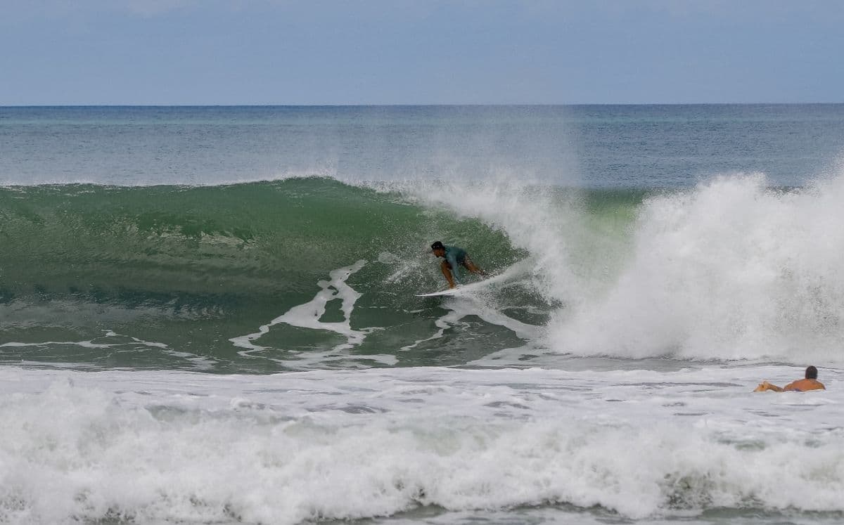 Surfer rides a green barrel wave with skill.
