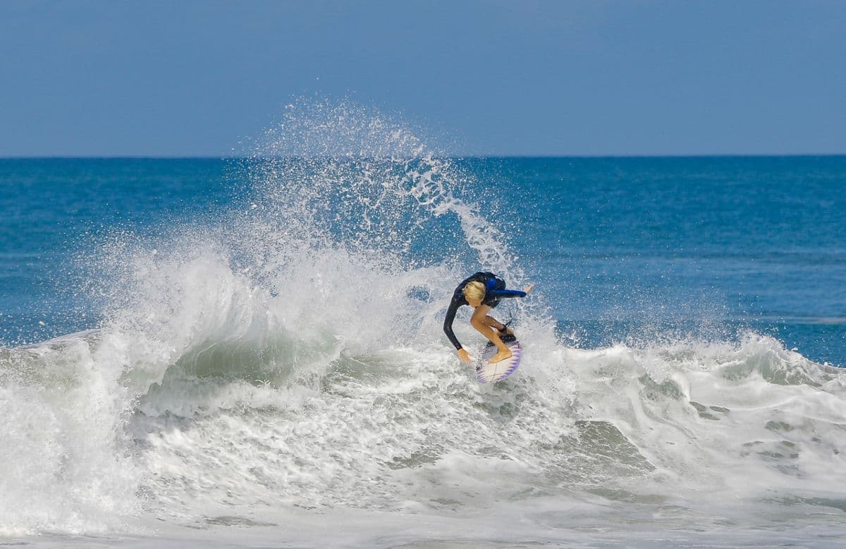 Surfer carves aggressively on a powerful wave.