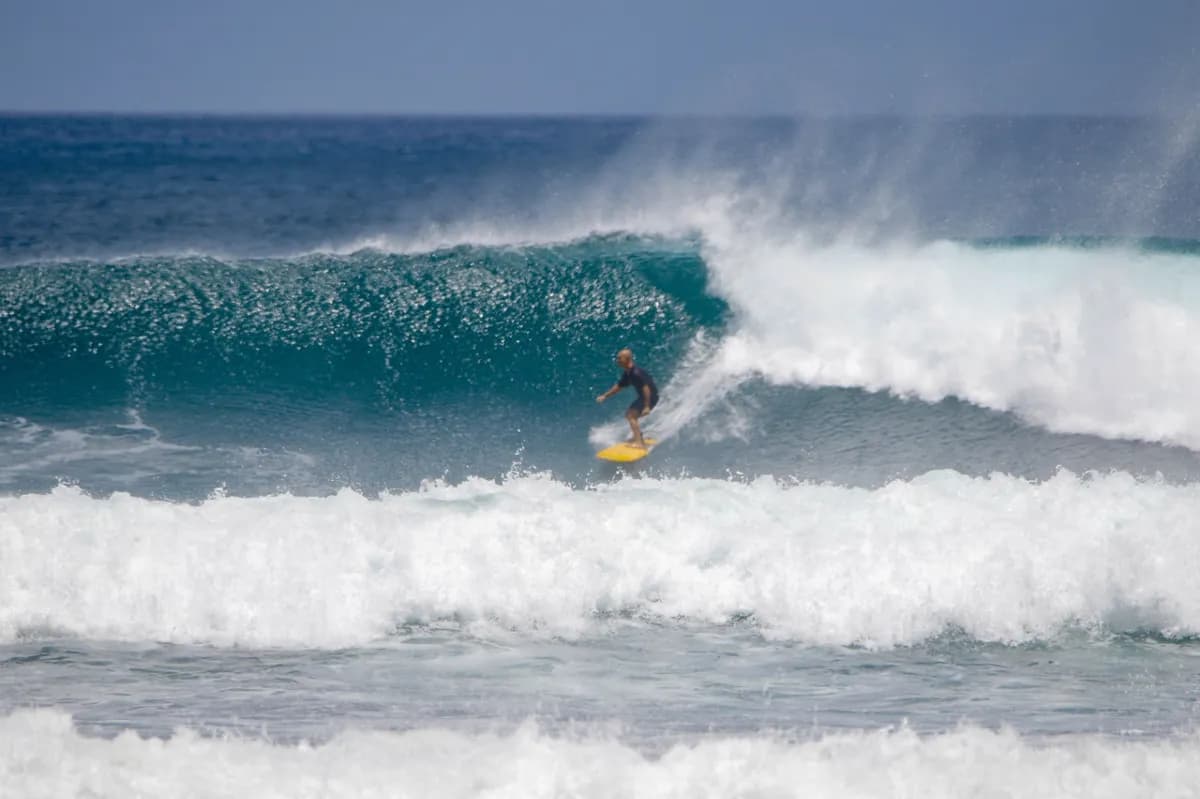 Surfer rides a powerful wave at Panga Drops.