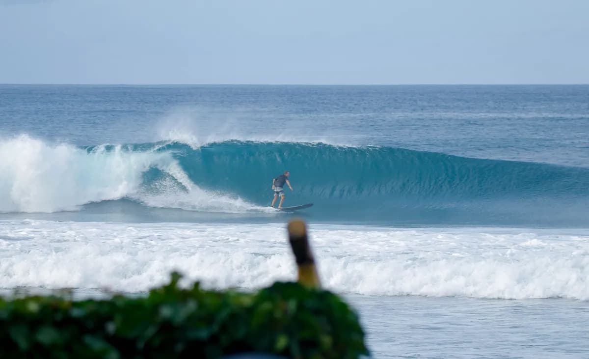 Surfer rides a perfect blue barrel at Playa Colorado.