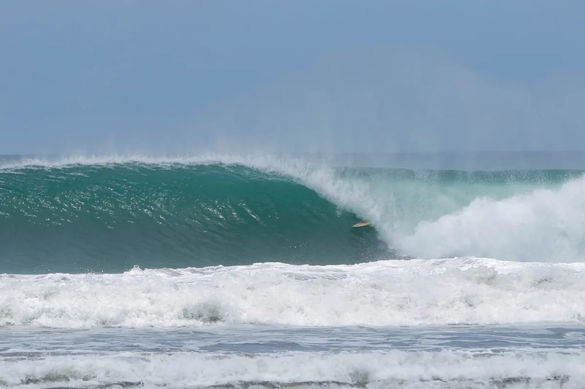Surfer disappears into a perfect, hollow barrel at Colorados.