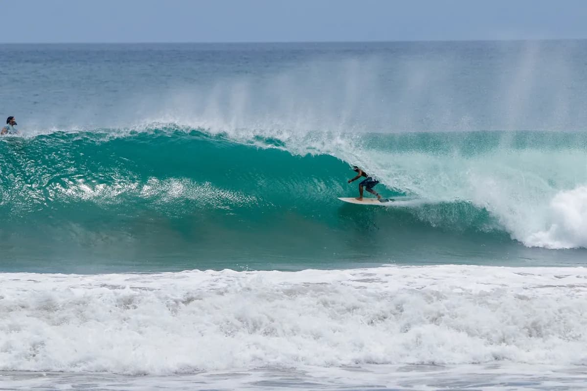 Surfer rides a perfect barrel with precision and style.