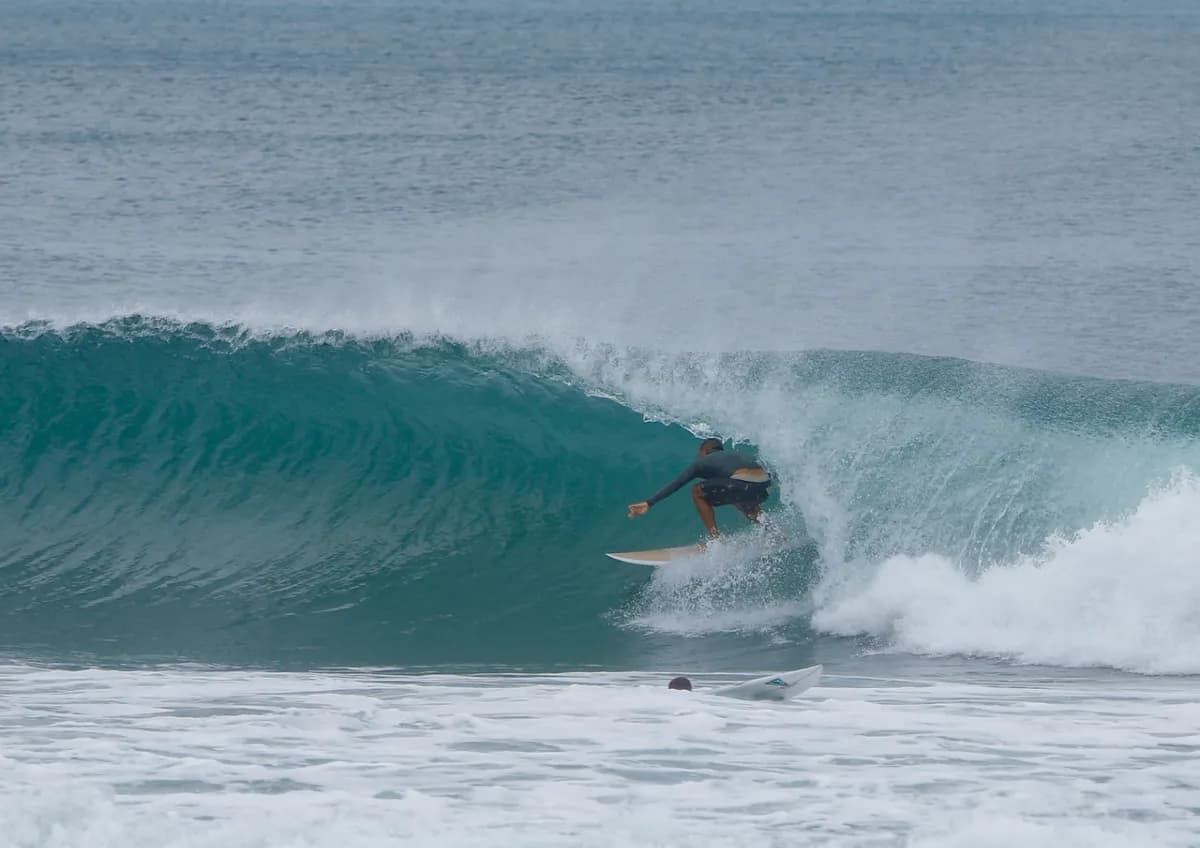 Surfer rides inside a hollow barrel at Playa Colorado.