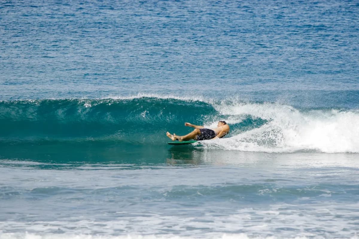 Surfer bauti-yelos wipes out on a small wedge.