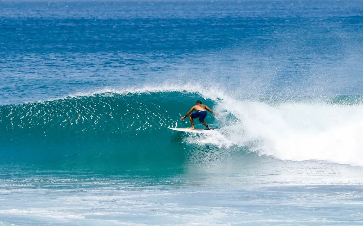 Surfer @reda-benhima skillfully rides a clean right barrel.
