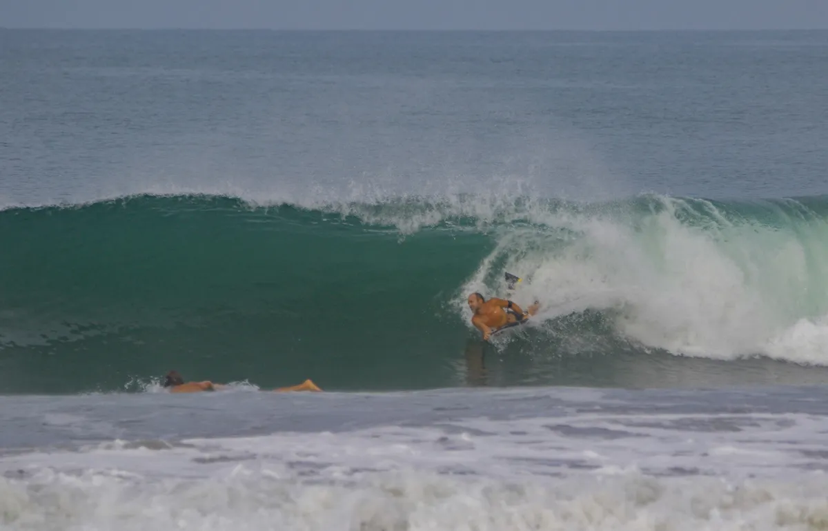 Surfer rides inside a powerful green barrel.