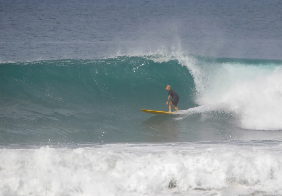 Surfer rides a powerful wave at Panga Drops.