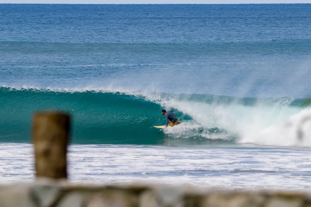 Surfer tucked perfectly inside a rolling barrel.