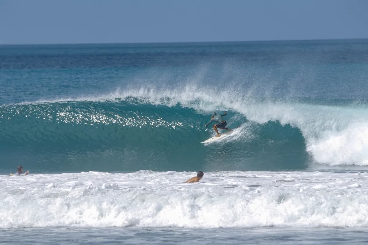 Surfer bruno-miguel-dias riding a hollow wave inside the barrel.