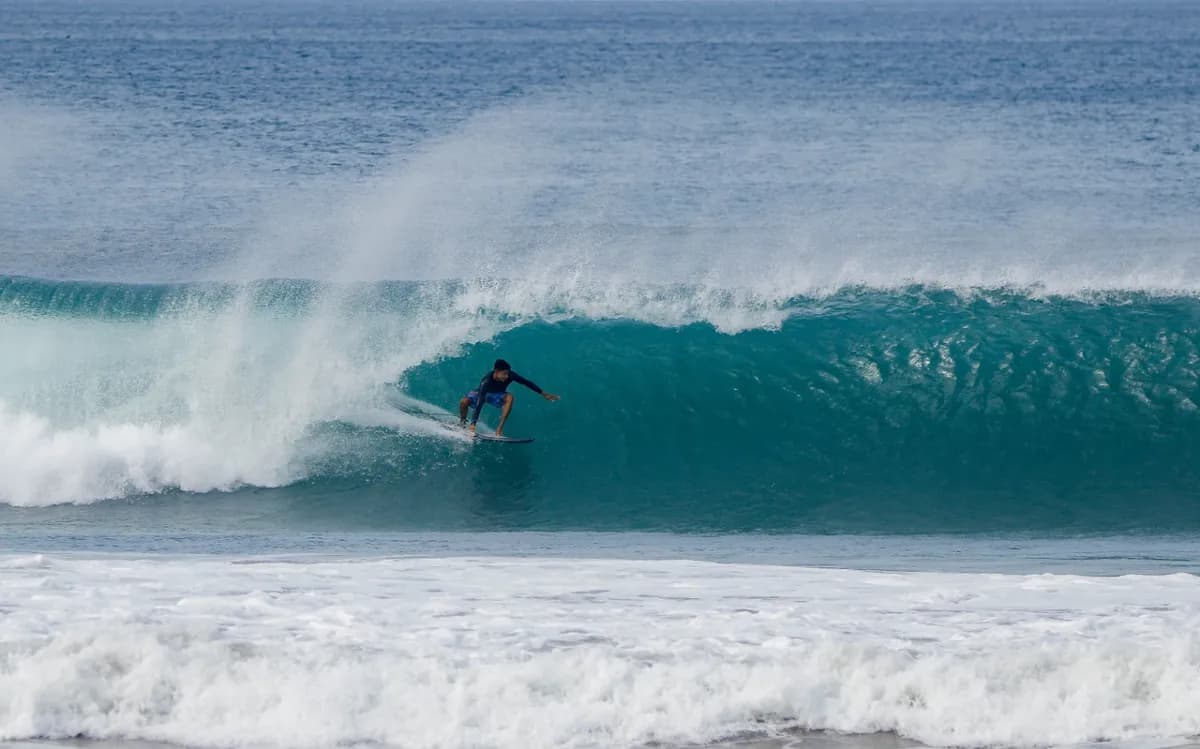 Surfer deep inside a clear blue barrel at Colorados.