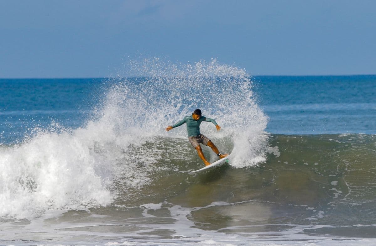 Surfer executes a sharp cutback on a powerful wave.