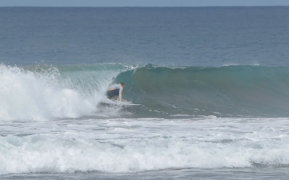 Surfer rides a hollow wave at Playa Colorado.