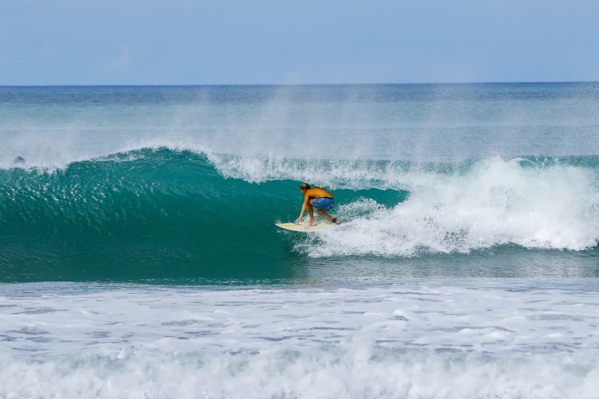 Surfer @yujiharrison rides inside a beautiful teal wave barrel.