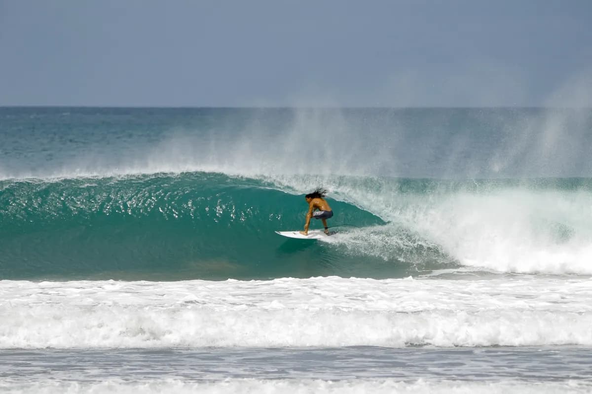 @momo skillfully rides inside a perfect turquoise barrel.