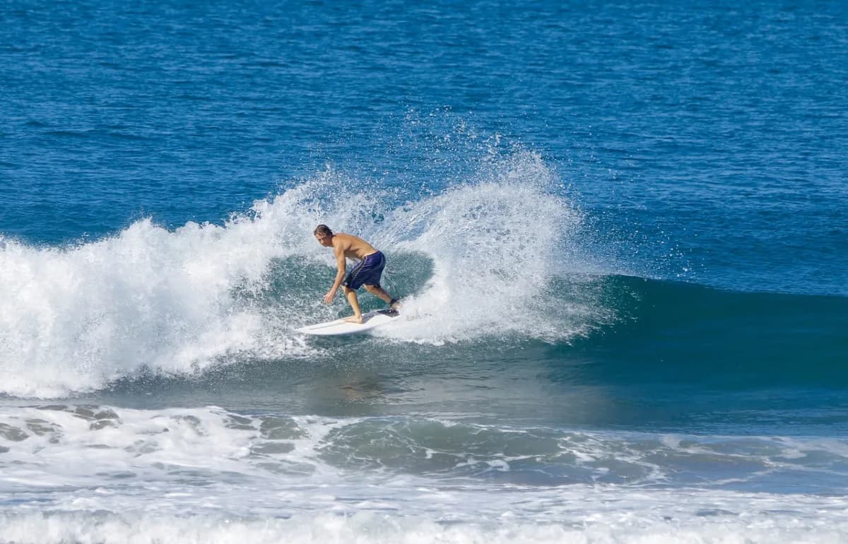 Surfer executes a stylish cutback on a peeling wave.