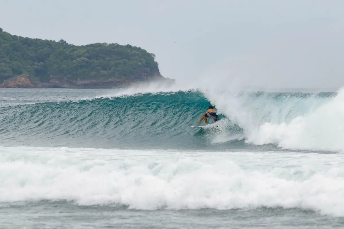 Surfer charges a barreling wave at Playa Colorado.