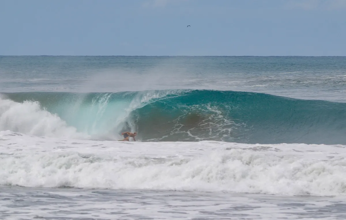 Surfer barrels through a hollow wave at Playa Colorado.