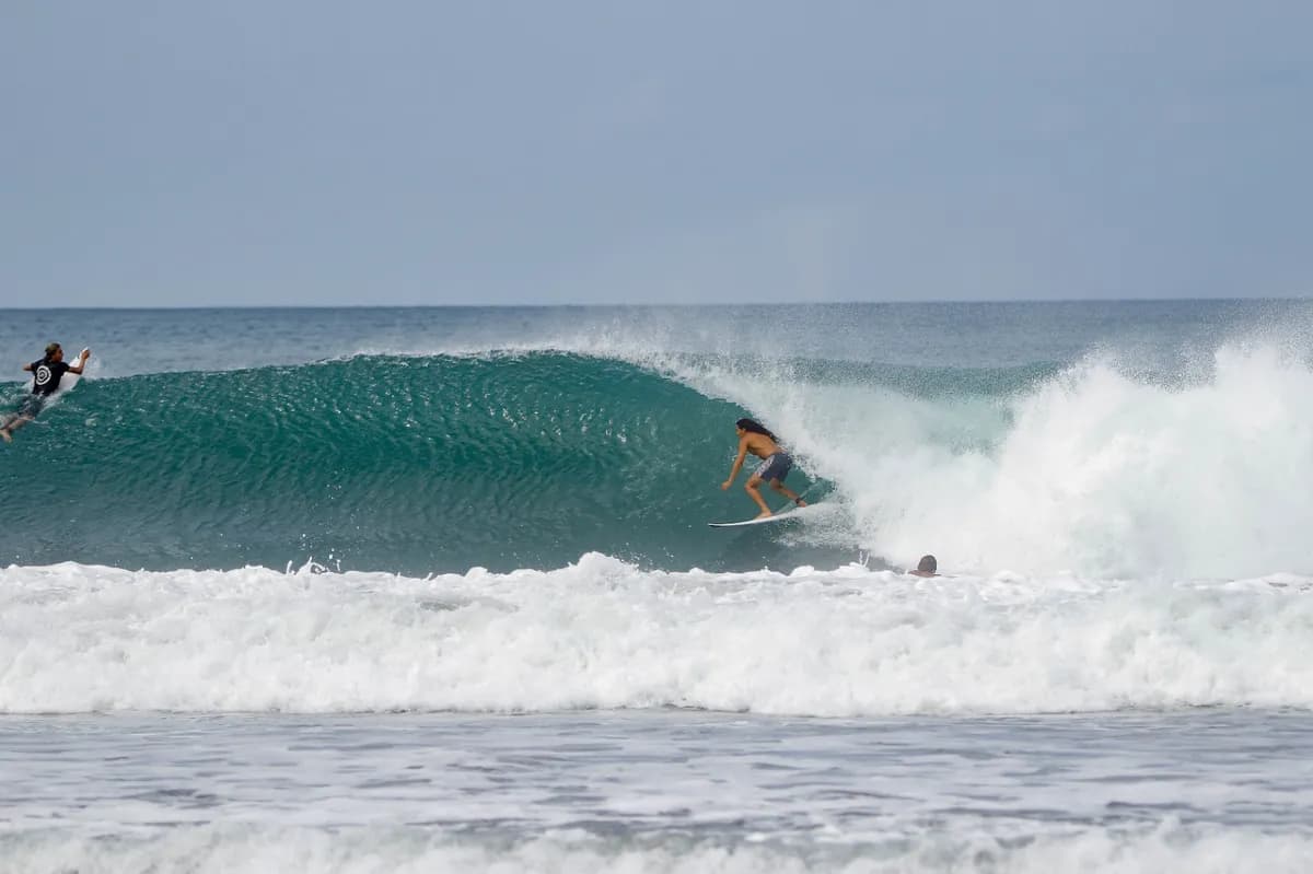 Surfer rides a beautiful green barrel at Playa Colorado.