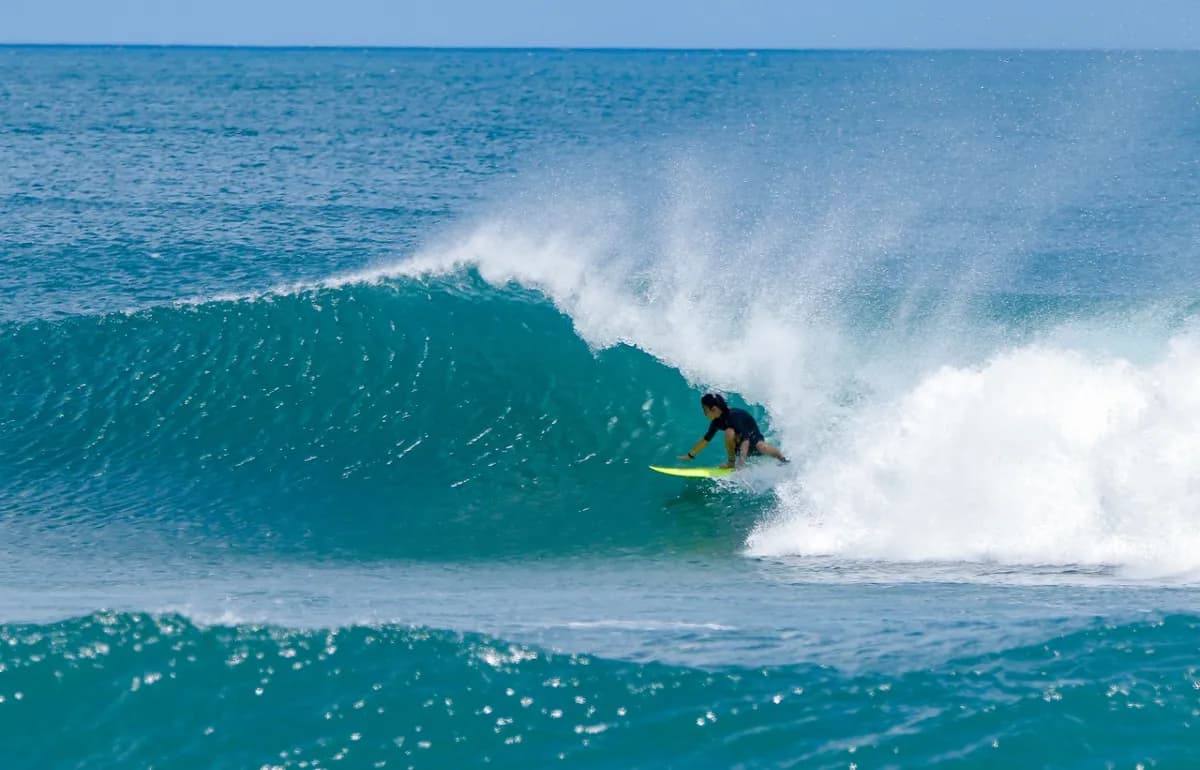 Surfer deep in a clear blue barrel at Playa Colorado.