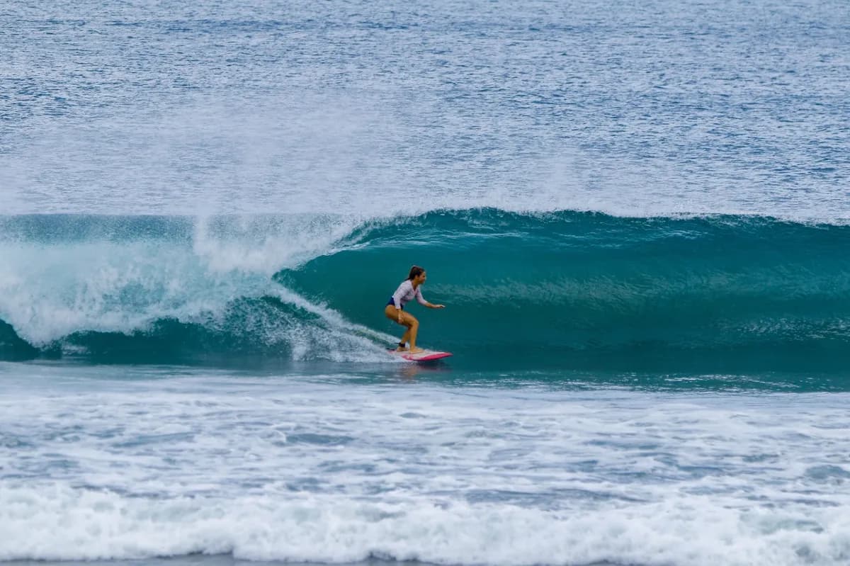 Surfer rides inside a perfect turquoise barrel at Playa Colorado.