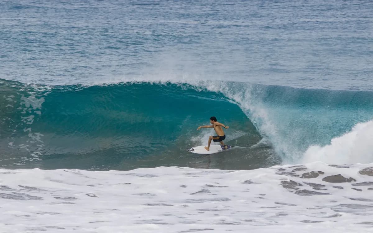 Surfer rides a perfect barrel with precision and style.