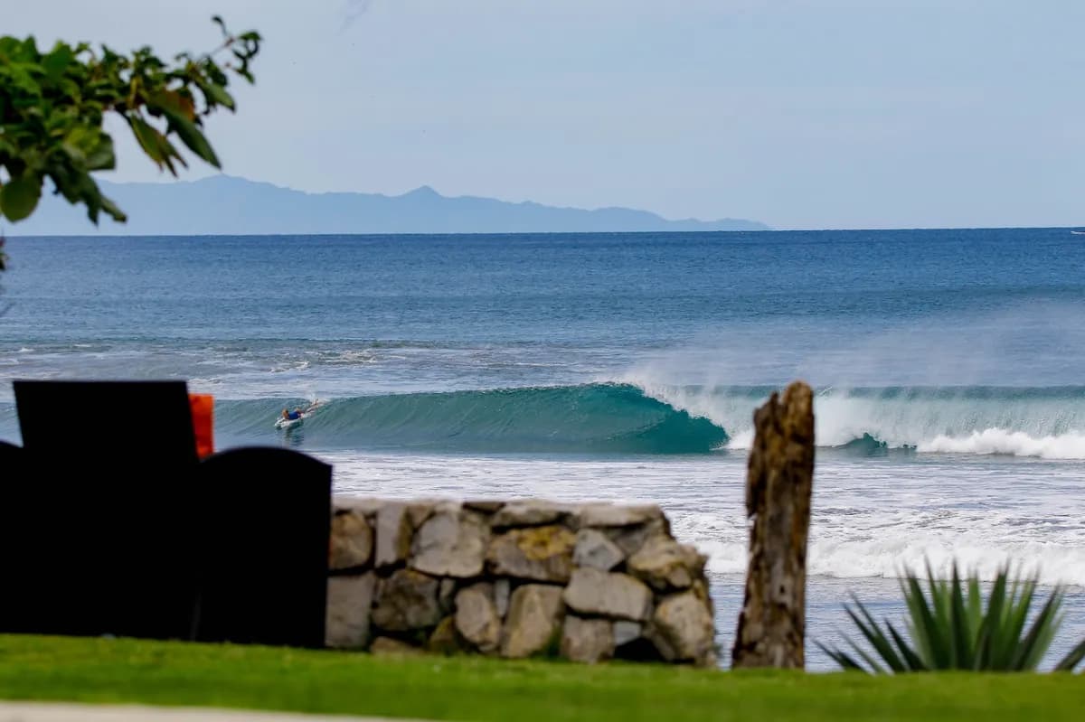 Surfer rides a perfect barrel on a sunny day.