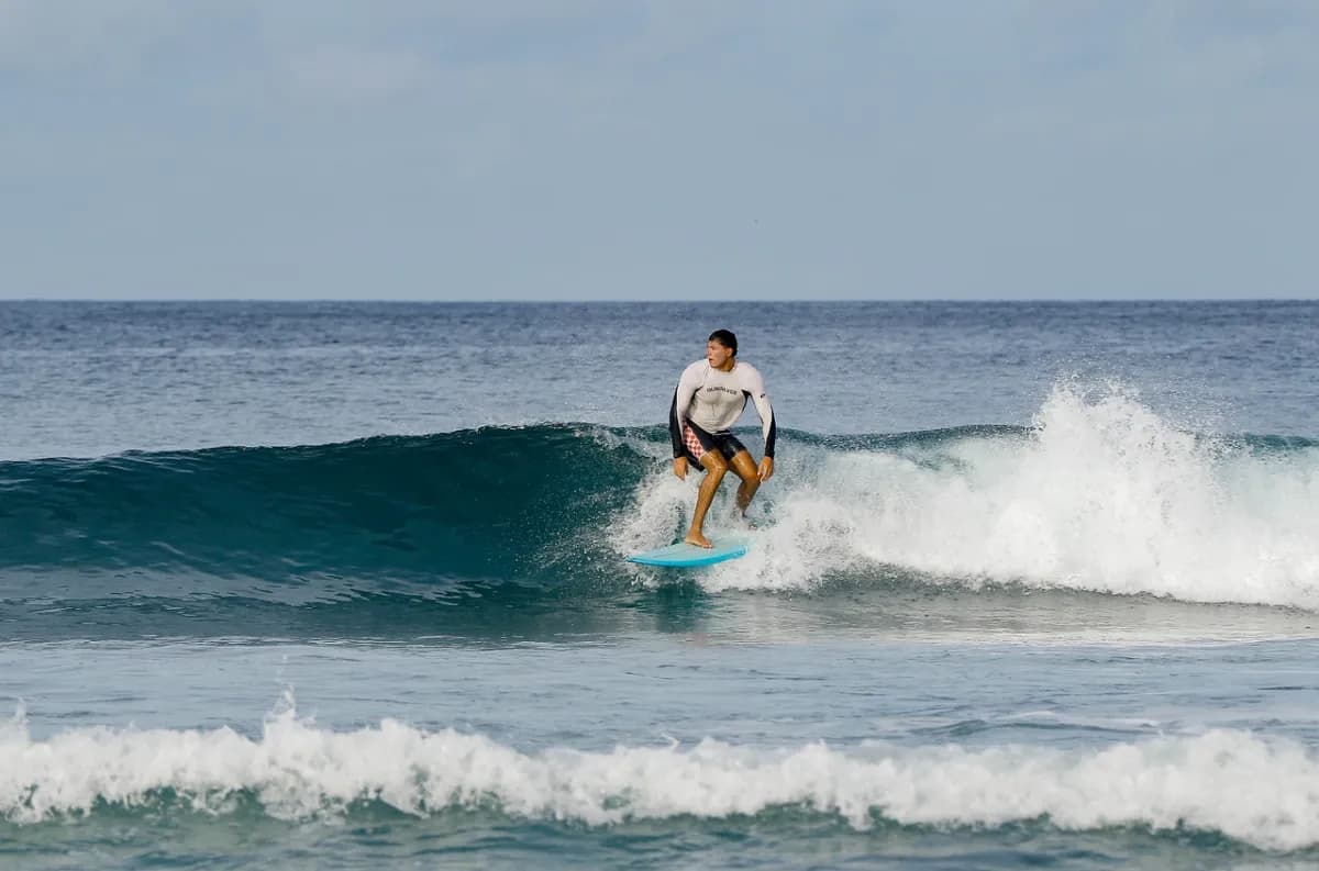 Surfer rides a small, peeling wave at Playa Colorado.