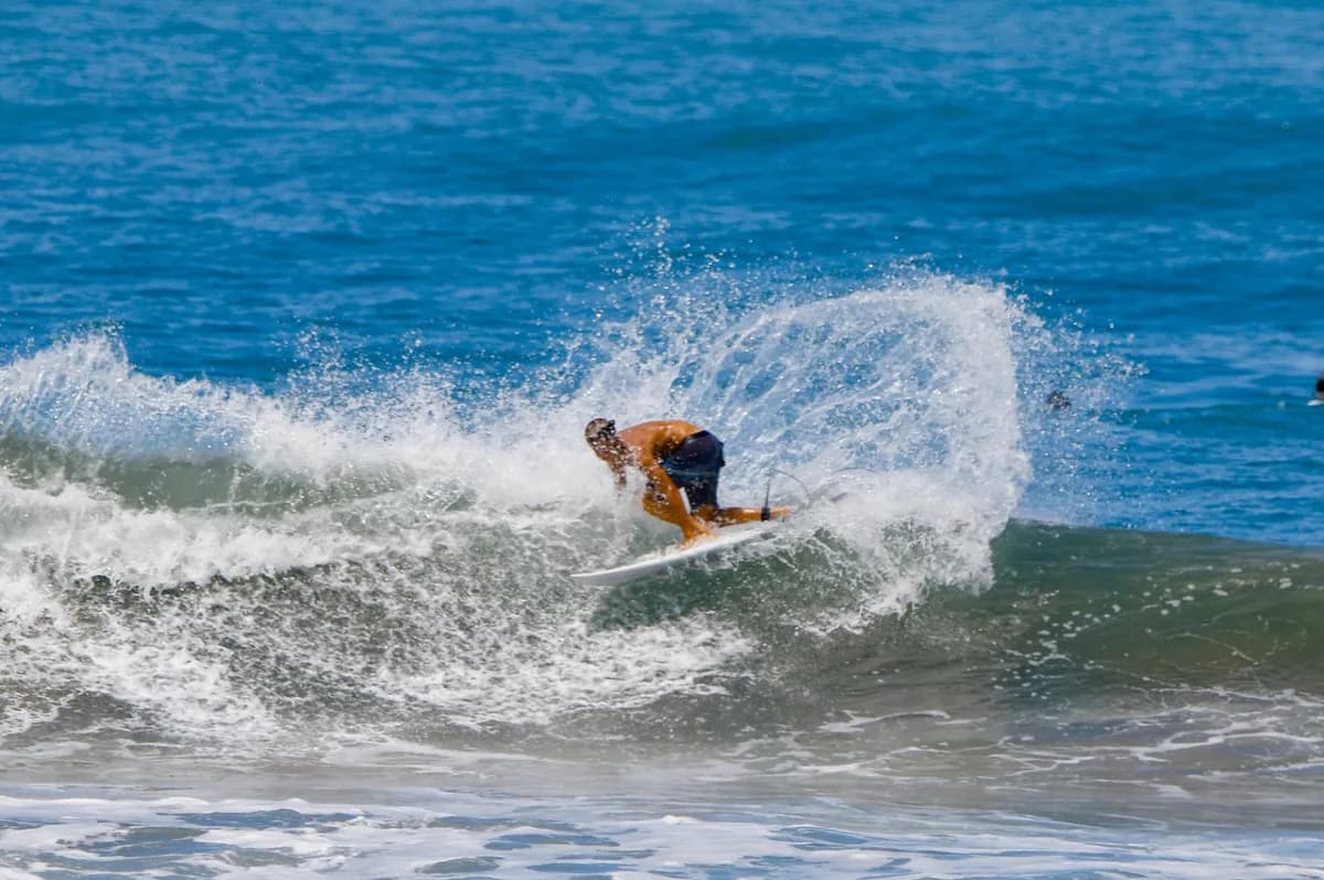 Surfer executes a dynamic cutback with a powerful spray.