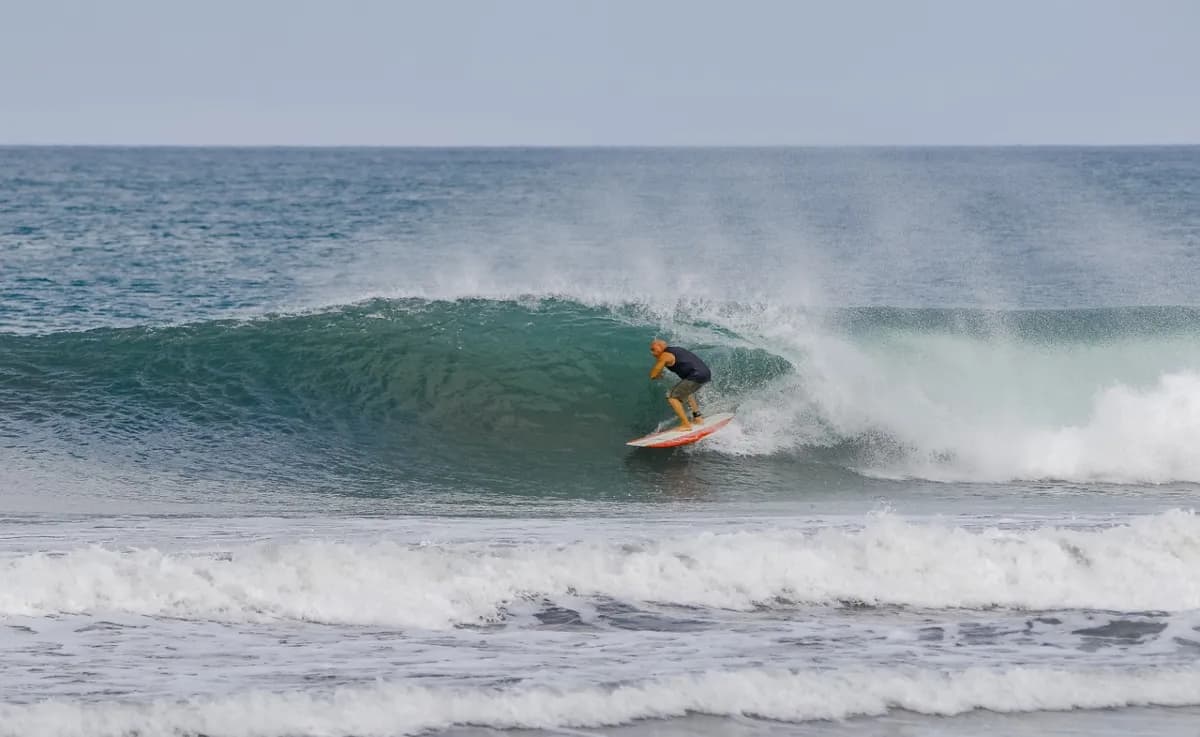 Surfer rides inside the ocean barrel gracefully.