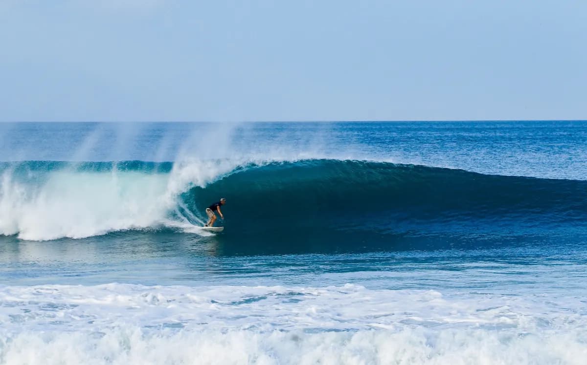 Surfer riding a smooth barrel at Playa Colorado.