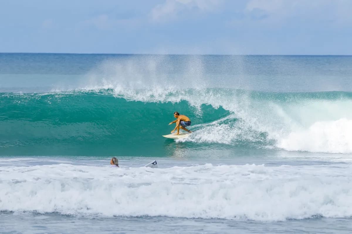 Surfer rides inside a smooth, green barrel wave.