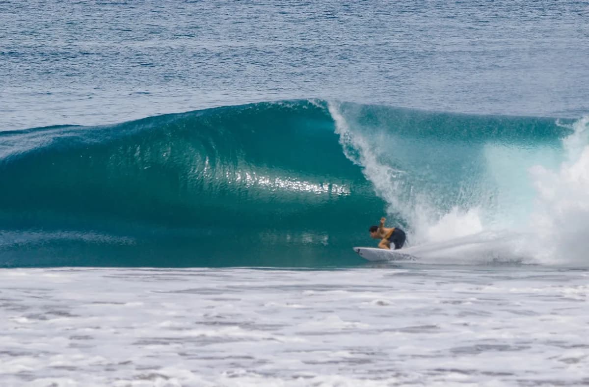 Surfer rides a perfect barrel at Playa Colorado.