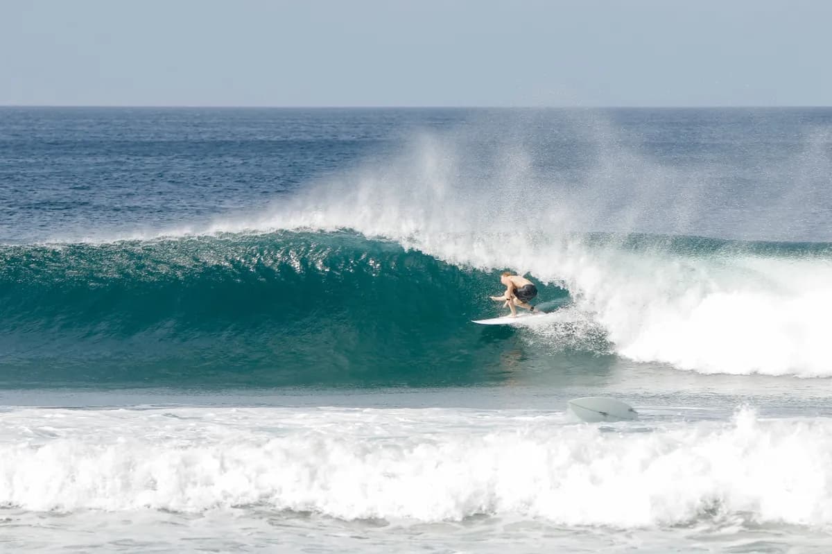 Surfer rides a perfect barrel at Playa Colorado.