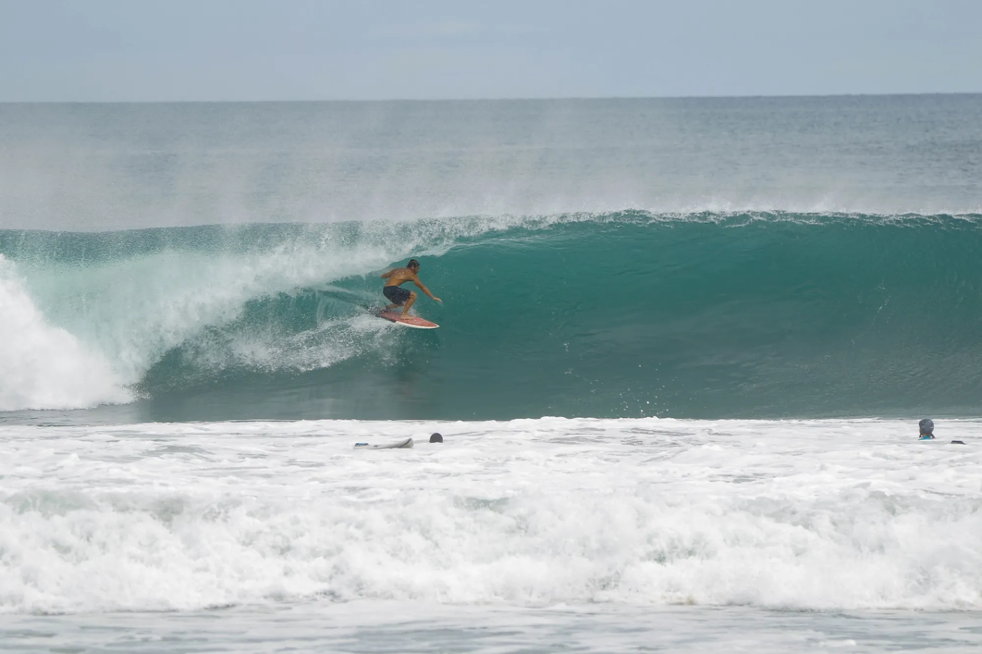 Surfer rides clean barrel wave at Playa Colorado.